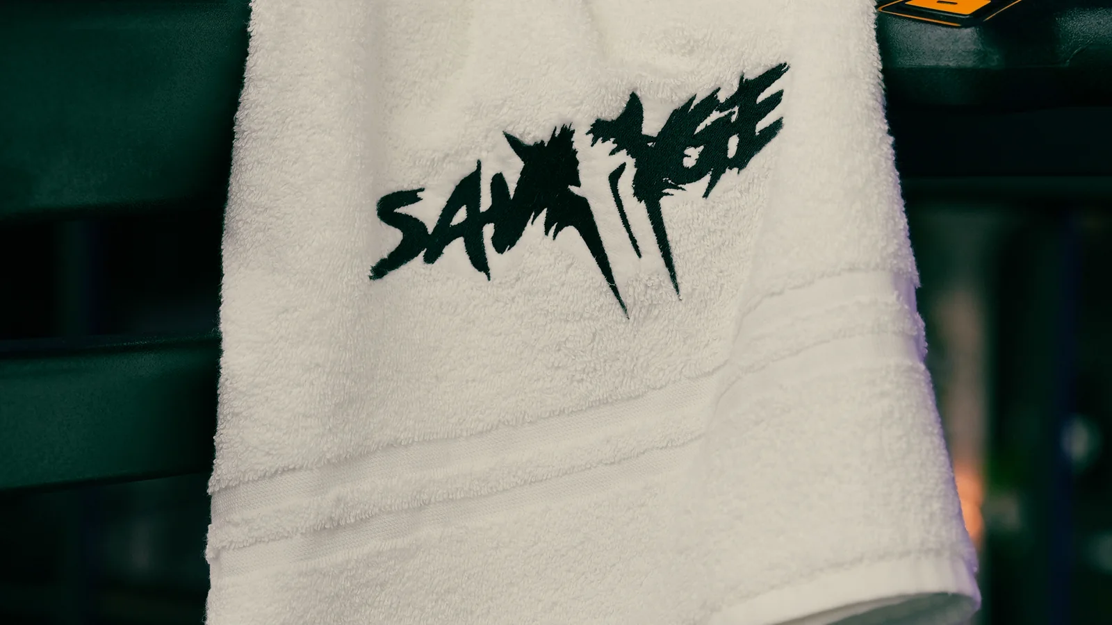 Branded Savage Elite Fitness towel on the training floor